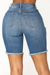 High Waist Blue Denim Jean Shorts With Rips in the front . Zipper fly.